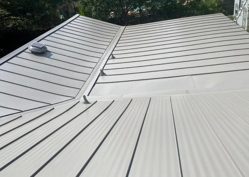 Solar attic fan installed on a metal roof for Roof Ventilation in Warrenville